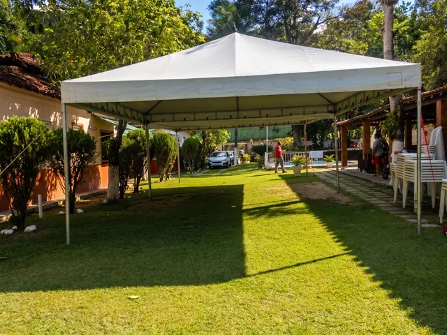 Tenda piramidal montada com pessoas ao redor